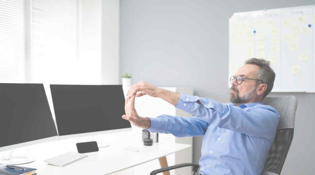 Man Flexing Hands in Home Office