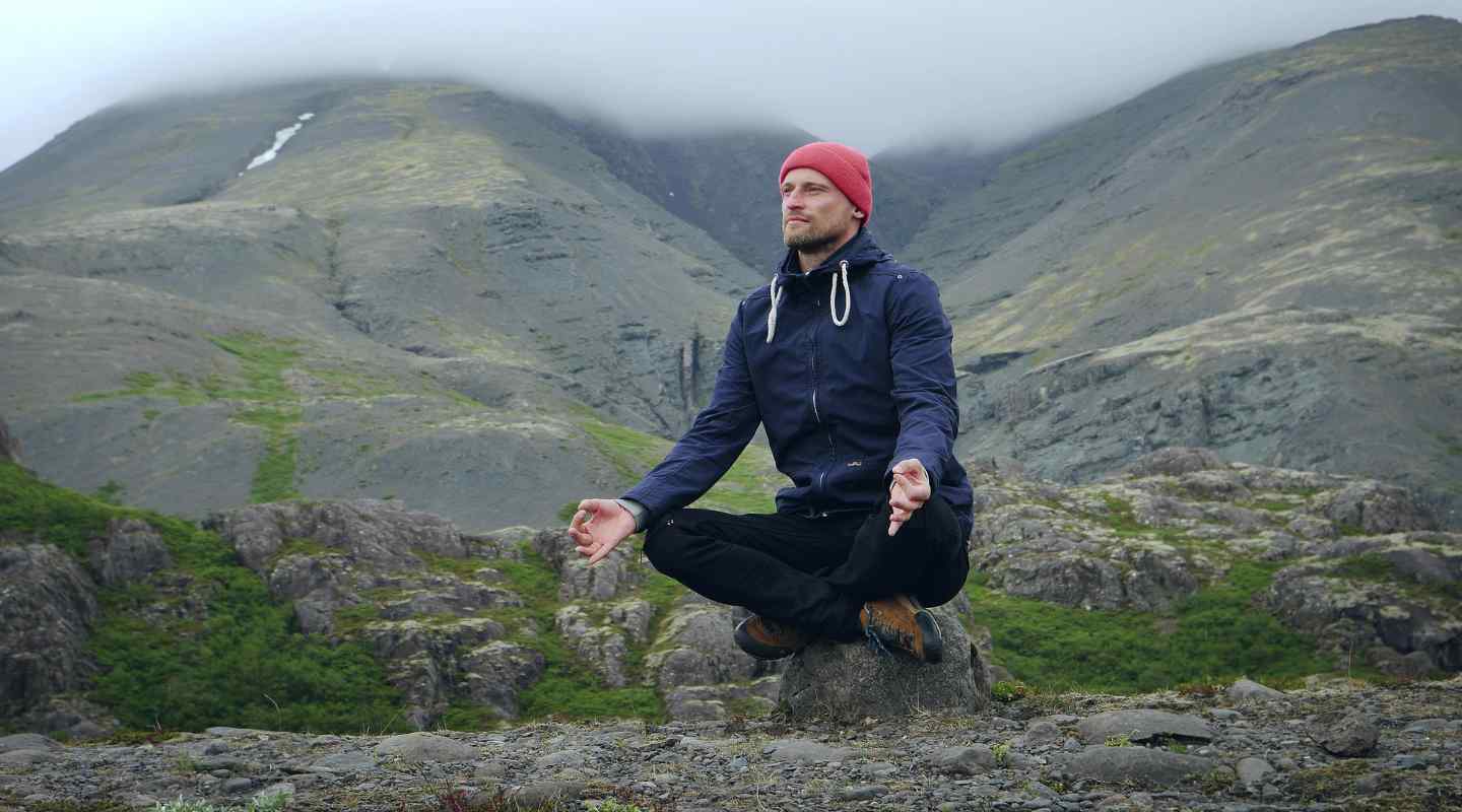 Man Meditating on Mountain