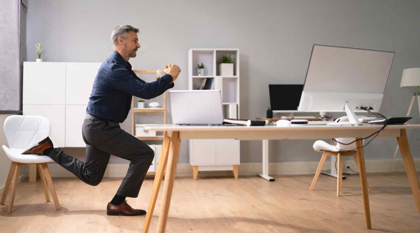 Man Stretching in Home Office