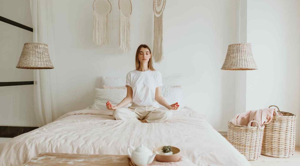Woman Meditating in Bedroom